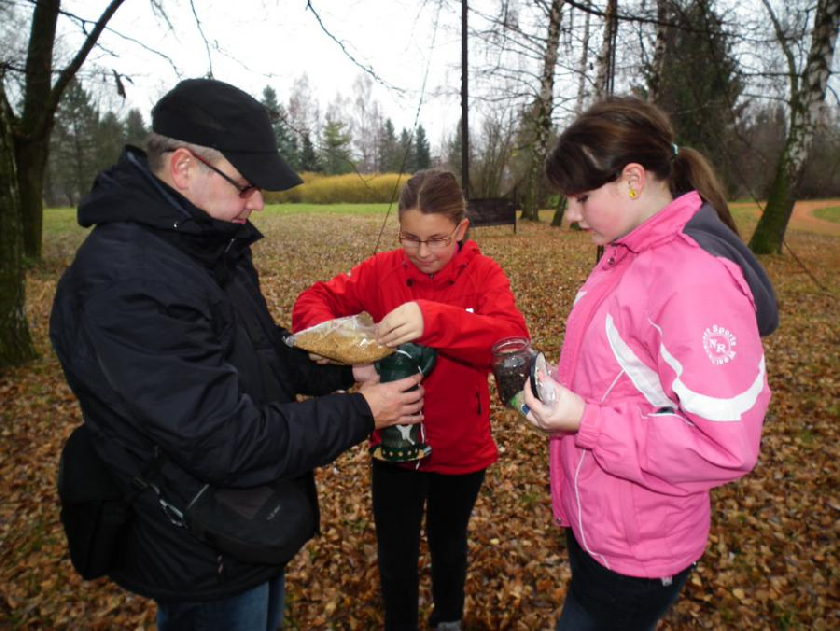 Eva a Klára pod dohledem pana prof. Macha plnà krmÃtka prosem a sluneÄnicÃ.